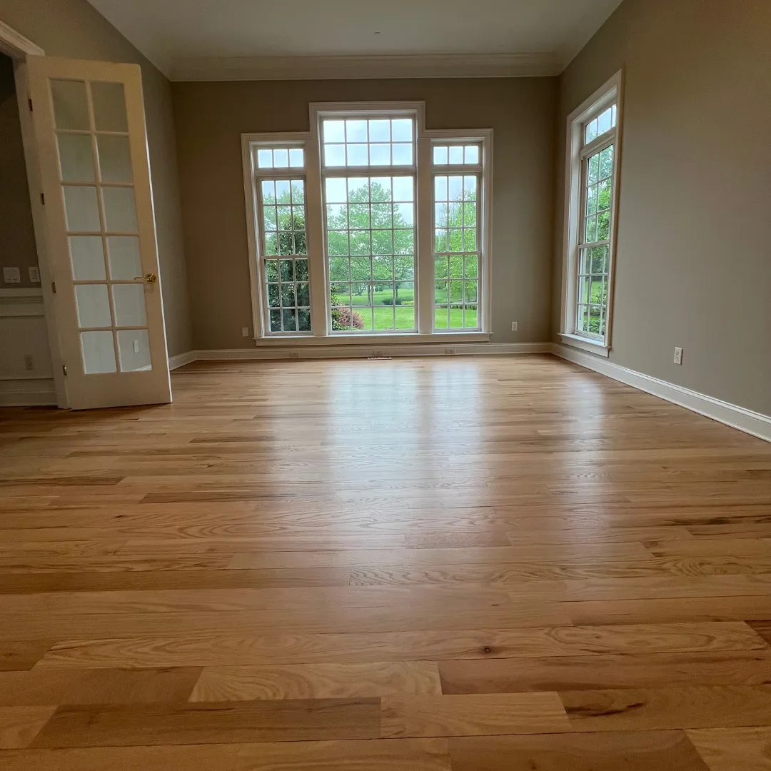 Hardwood flooring in a bright room before service planning and preparation