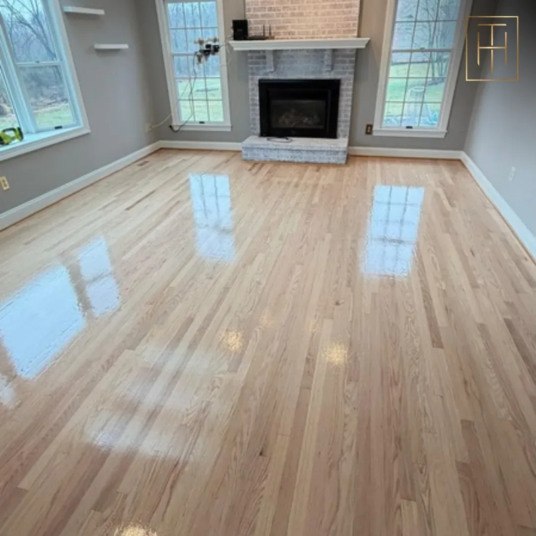 Refinished red oak hardwood floor in Philadelphia living room with brick fireplace and gray walls