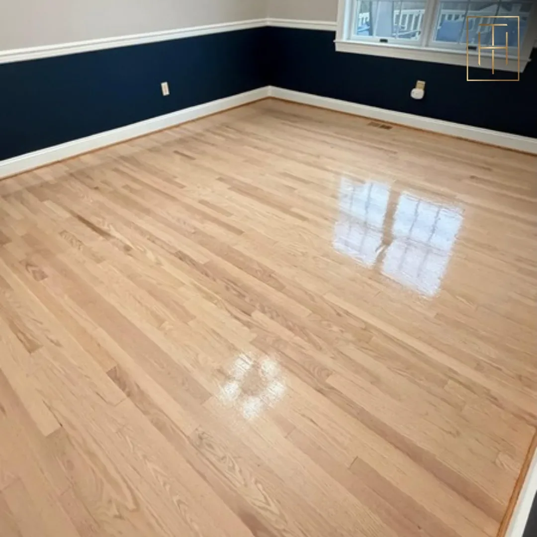 Newly refinished red oak hardwood floor in Wayne PA dining room with navy accent wall