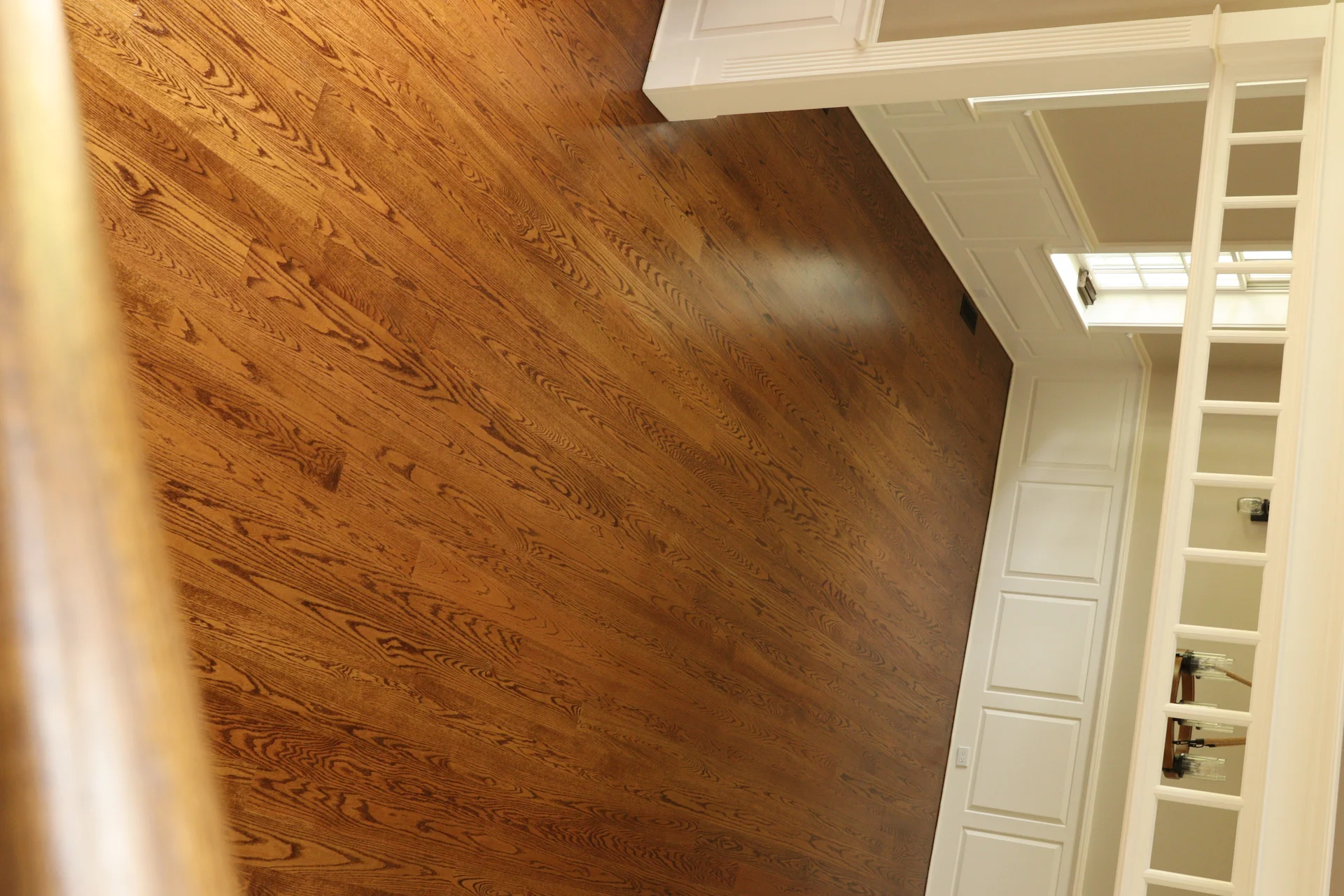 Custom Hardwood Flooring Installation Beautiful new hardwood floor installation with rich brown tones and distinct grain patterns. by Tesla Hardfloor in Doylestown