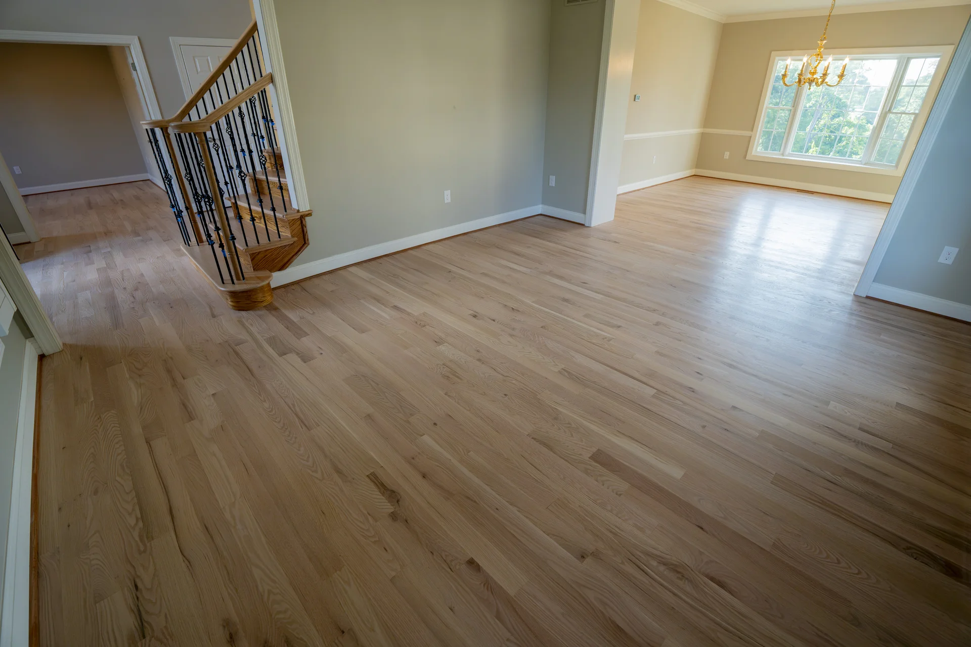 Versatile and Stylish Vinyl Flooring Newly installed light natural hardwood flooring throughout a home's entryway and living room. by Tesla Hardfloor in Moorestow