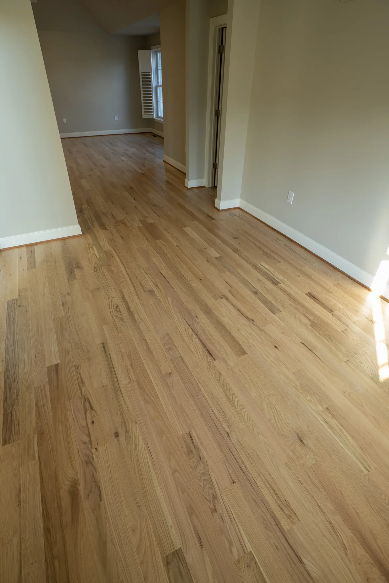 Newly Installed Hardwood Flooring in Villanova, PA Newly installed light natural hardwood flooring in a spacious, empty room with light walls. by Tesla Hardfloor in Villanova,