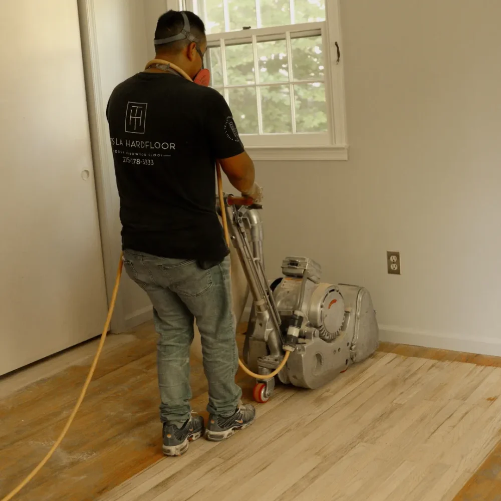 Professional floor refinishing service restoring hardwood floors with dustless sanding